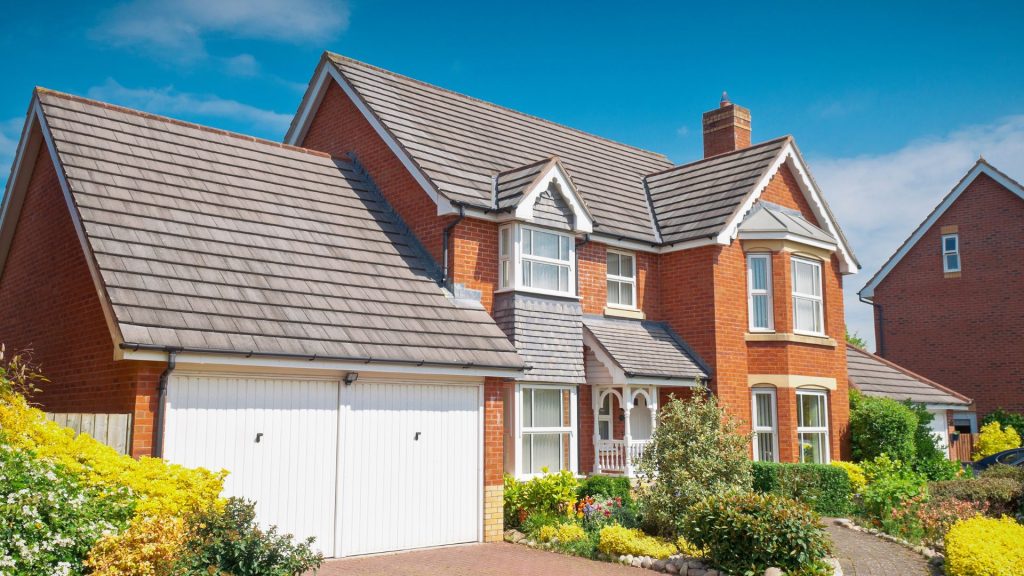 Brick home with a tiled roof and an attached garage