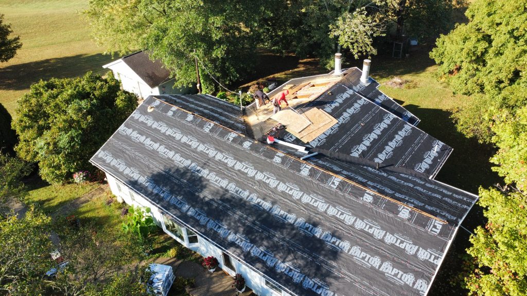 Aerial view of a roof mid replacement with underlayment down