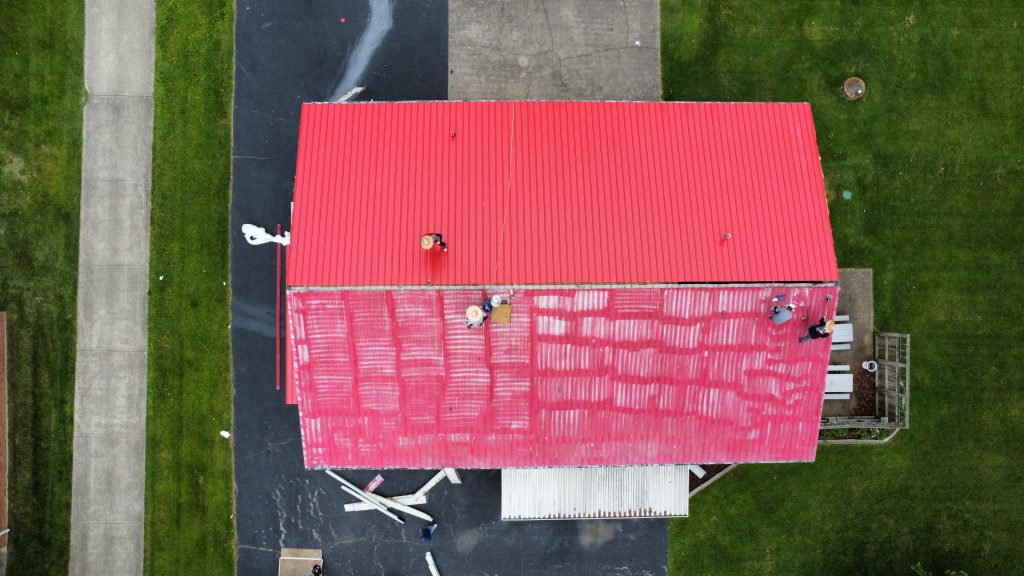 Aerial view of a building with a new red metal roof