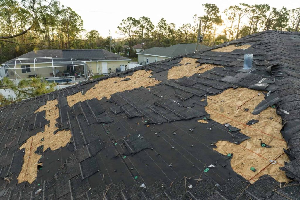 Roof with sections of shingles stripped back to the decking