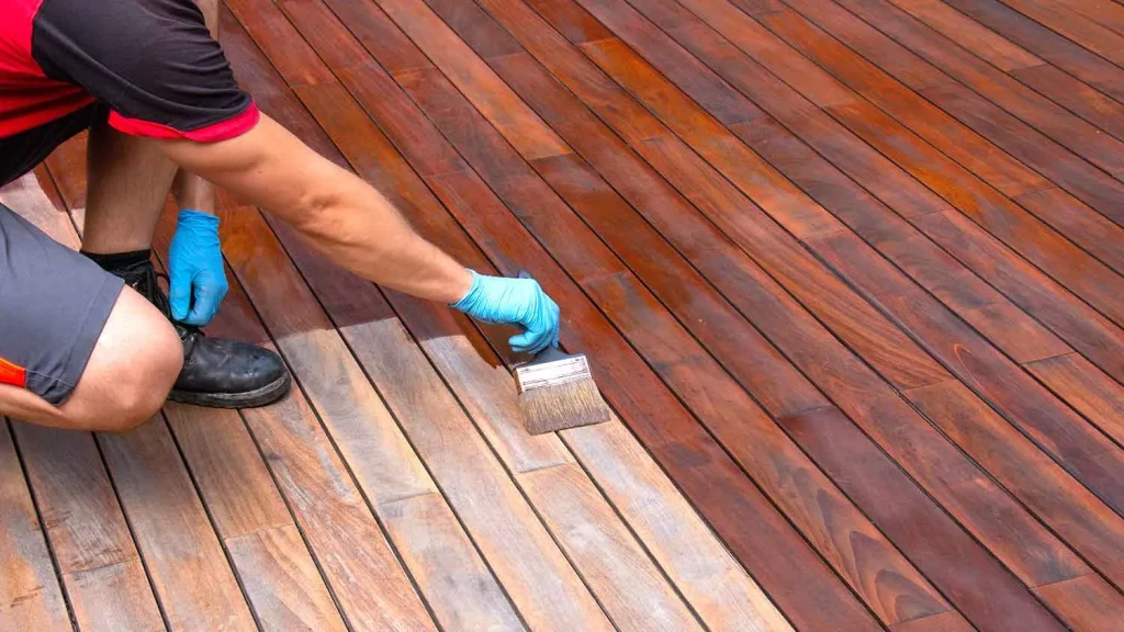 Staining a wooden deck by hand